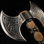 Double-bladed Viking axe with Celtic knotwork engraving, wood handle wrapped in black leather