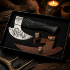 Ornate curved blade with a black carved handle, displayed in a black presentation box with a brown leather sheath and decorative metal fasteners.