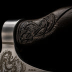 steel axe head meeting a dark wooden handle carved with Viking knotwork, with dragon etching visible on the blade below.