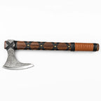 Single-blade hatchet with wood handle wrapped in black and tan leather, white background