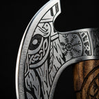 traditional curved axe with intricate engraved metalwork, featuring a stylized animal motif and Nordic-inspired symbols, paired with a carved wooden handle against a dark background.
